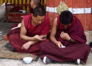 novice monks texting small 300x217 Phone & internet access in China