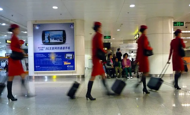 Chinese airline attendants walking to their next destination 