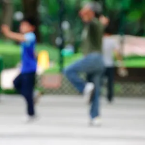 Blurred image of two Chinese people doing Tai Chi outdoors