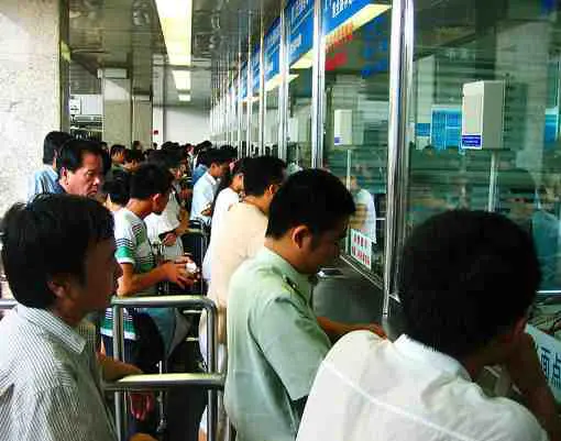 People purchasing their train tickets at the station