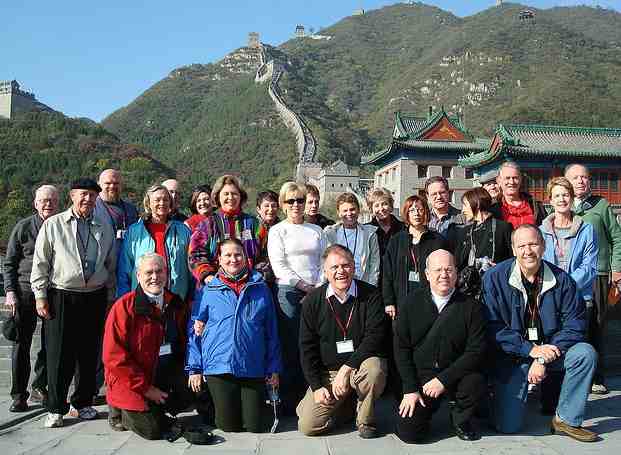 Organized tour group in China, taking a picture on the Great Wall.