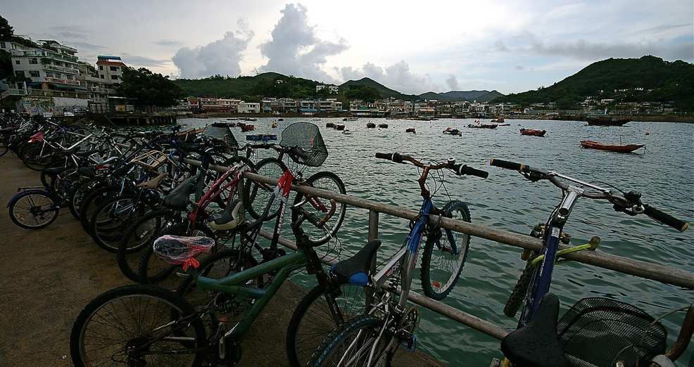 Bikes alongside a railing near the seaside