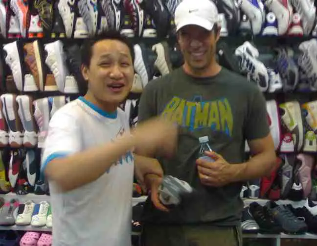 A foreigner doing his bargaining in China at a shoe store