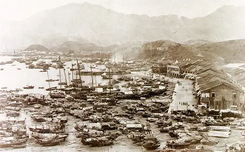 An old photo of a Chinese port with a fleet of boats