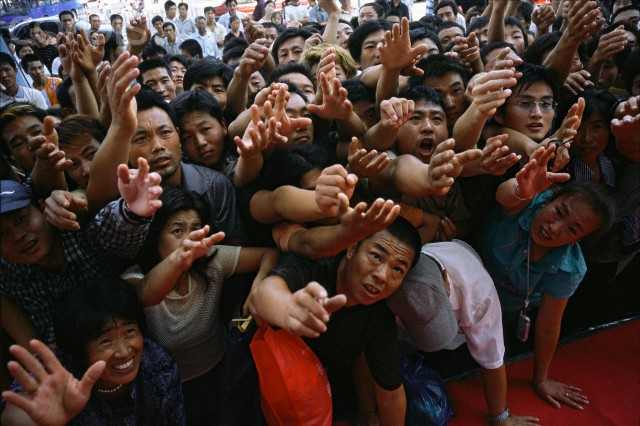 Onlookers stand by the red carpet clamoring to touch you