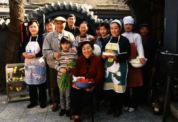 A friendly Chinese family that is smiling together