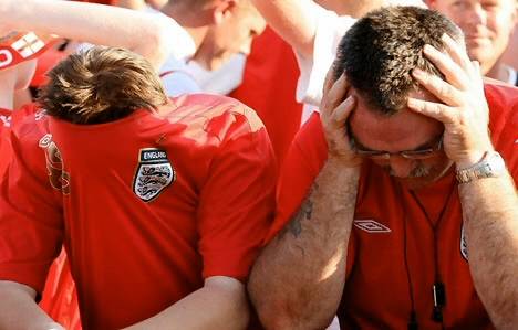 Two western men appear shamed because their team is losing.