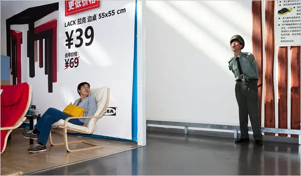 Chinese police officer standing guard at an IKEA in China.