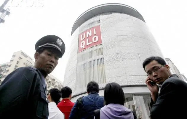 Two Chinese men suspiciously looking at a camera.