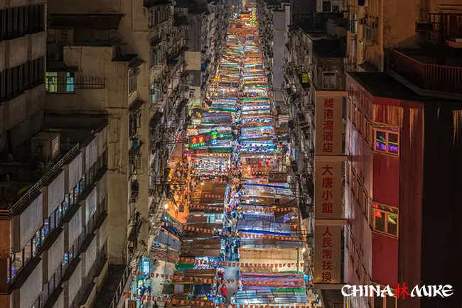 A street lit up with shopping signs in Hong Kong, China